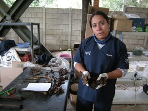 Alma Vasquez of FAFG explains signs of violent death on bones at La Verbena cemetery. Photo by Barbara Borst