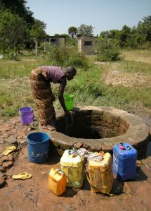 A girl called Happiness draws water from the one free well in Ulyankulu, Tanzania. Photos by Barbara Borst