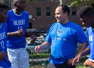 Elvis Garcia Callejas, coach and Catholic Charities migration counselor, huddles with his team during a Saturday game. Photo by Katie Schlechter